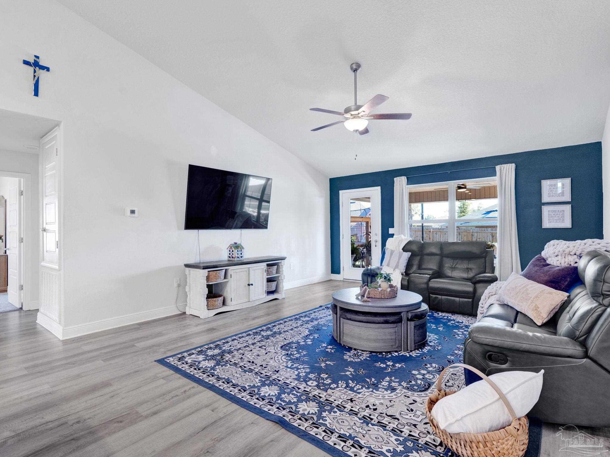 5956 Parsonage Circle Milton, FL 32570 - Photo 25 of 66 a living room with furniture and a flat screen tv