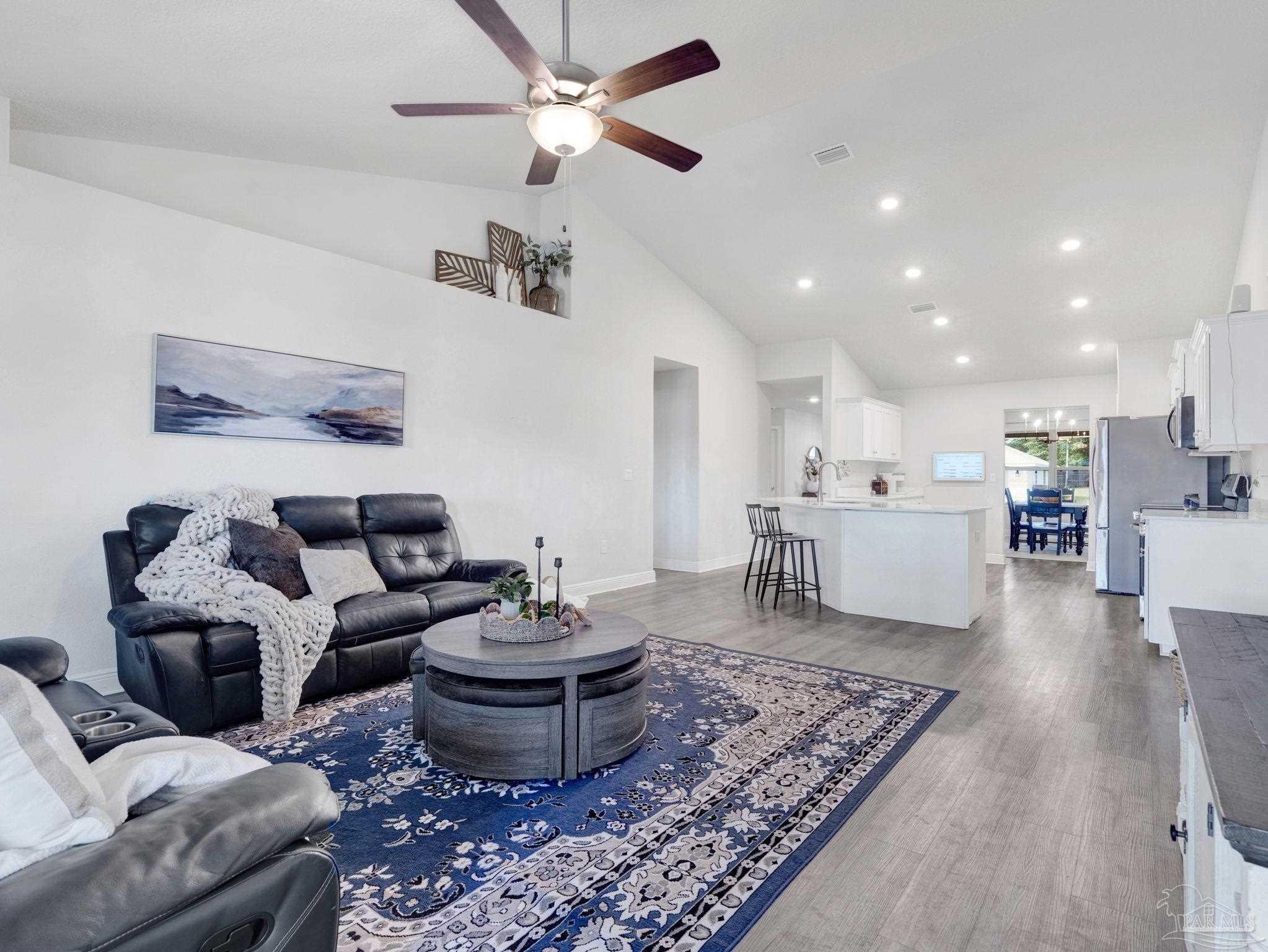 5956 Parsonage Circle Milton, FL 32570 - Photo 26 of 66 a living room with furniture and kitchen view
