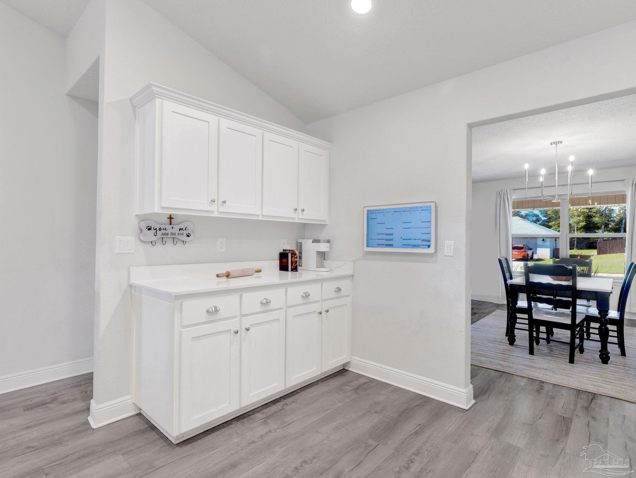 5956 Parsonage Circle Milton, FL 32570 - Photo 29 of 66 a kitchen with a sink cabinets and wooden floor