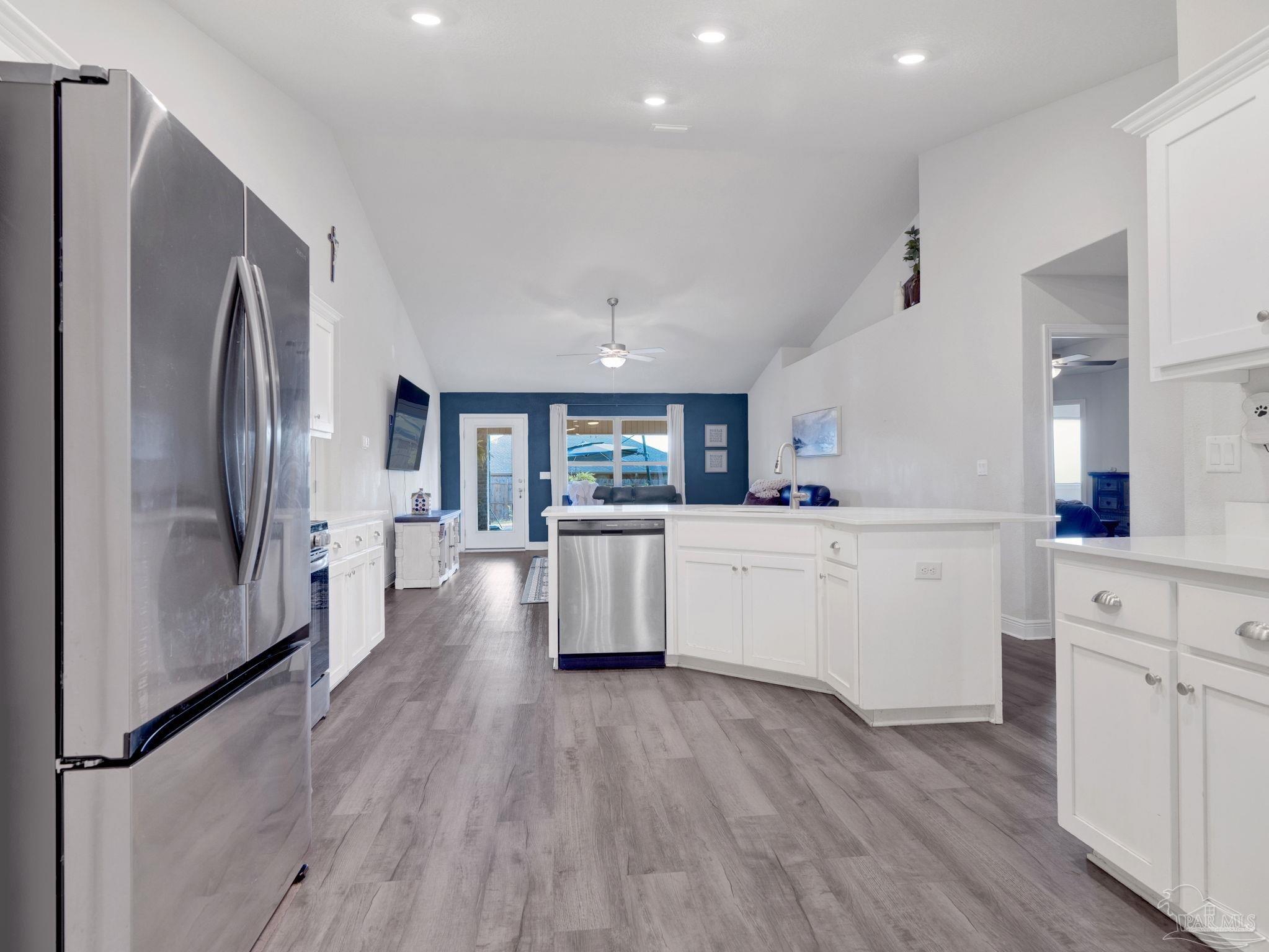 5956 Parsonage Circle Milton, FL 32570 - Photo 30 of 66 a kitchen with white cabinets and stainless steel appliances