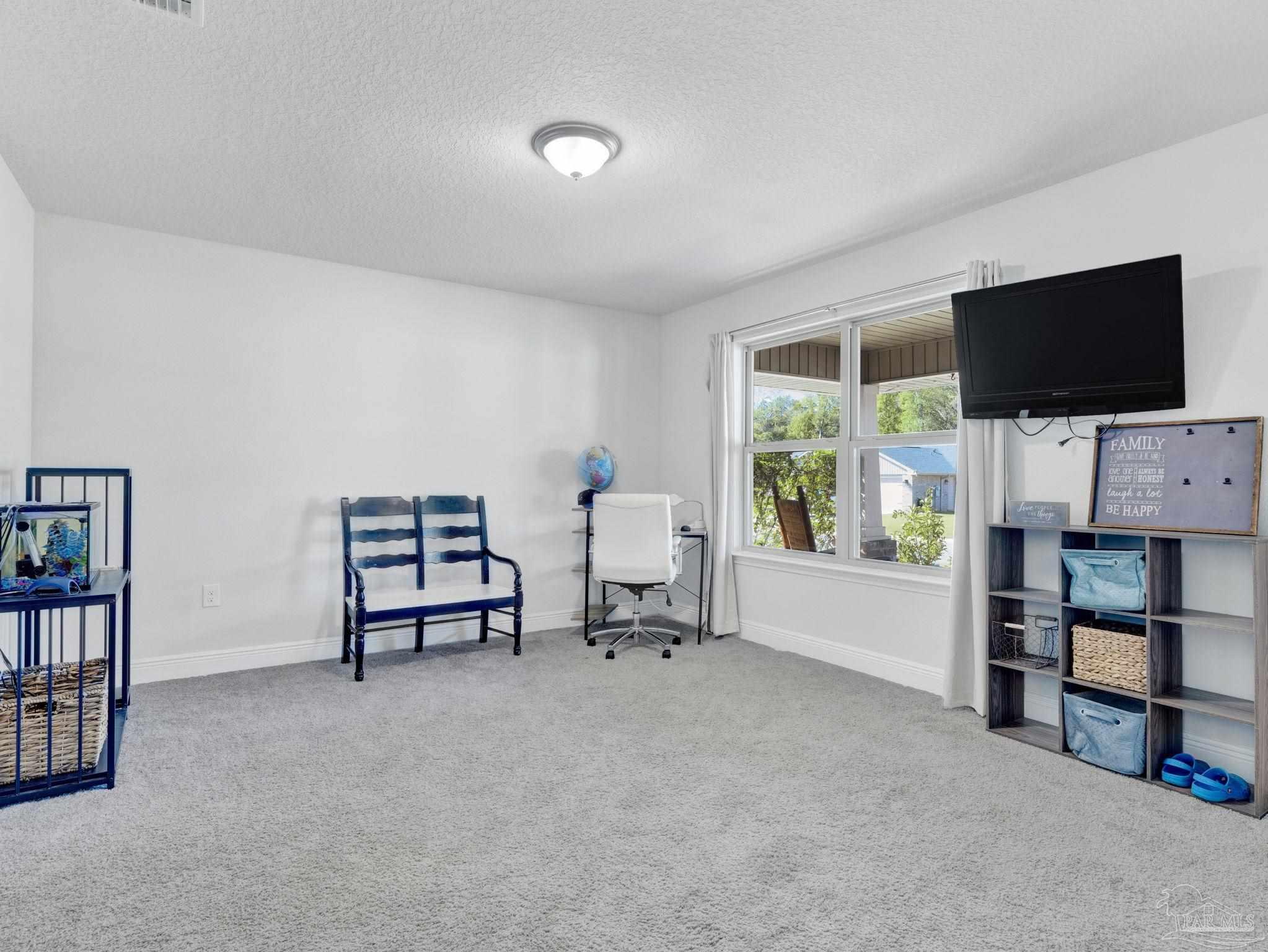 5956 Parsonage Circle Milton, FL 32570 - Photo 32 of 66 a living room with furniture and a flat screen tv