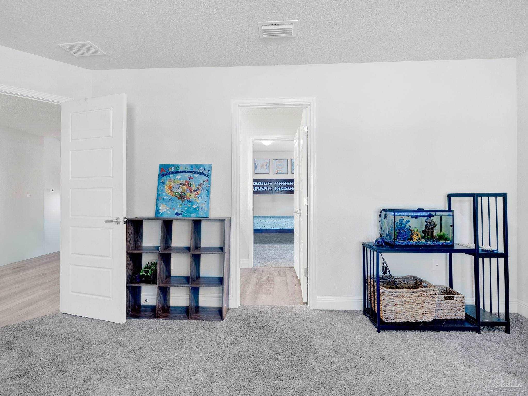 5956 Parsonage Circle Milton, FL 32570 - Photo 34 of 66 a view of an empty room with cabinet and wall