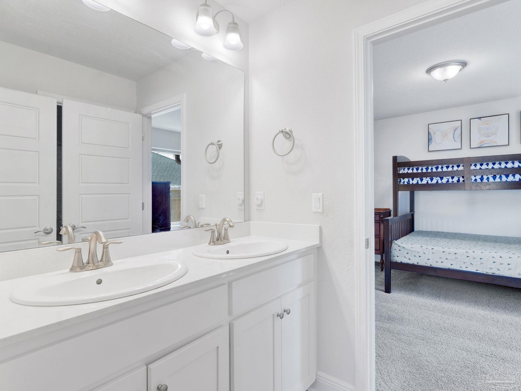 5956 Parsonage Circle Milton, FL 32570 - Photo 35 of 66 a en suite bathroom with double vanity sink and a mirror