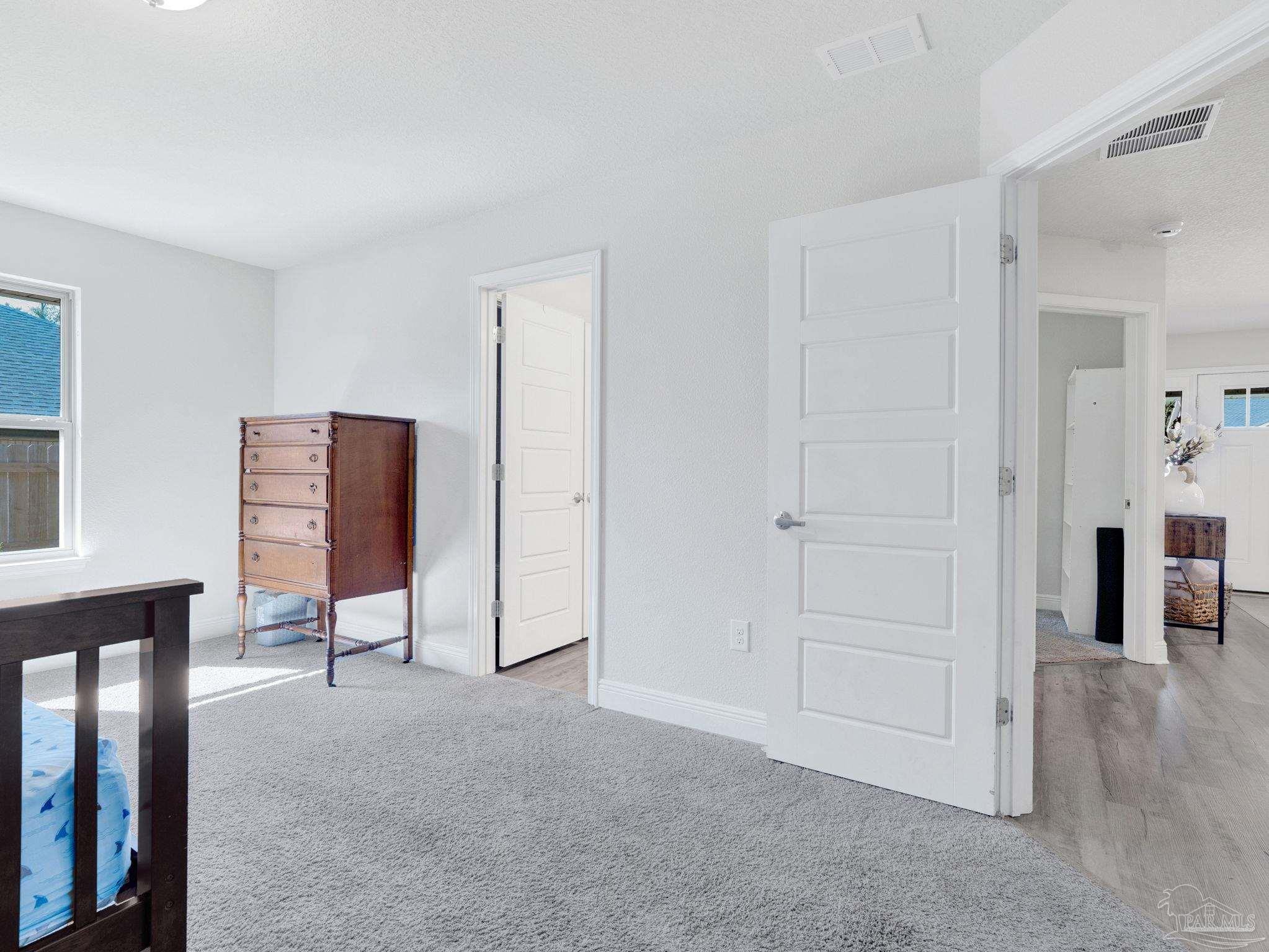 5956 Parsonage Circle Milton, FL 32570 - Photo 39 of 66 a view of an empty room with wooden floor and windows