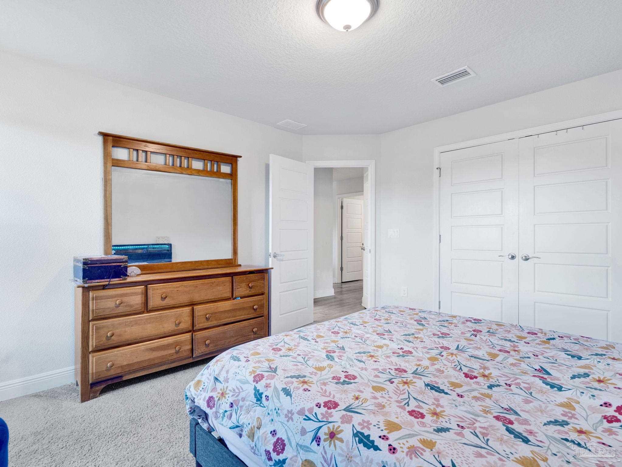 5956 Parsonage Circle Milton, FL 32570 - Photo 42 of 66 a bedroom with a bed and a mirror on dresser