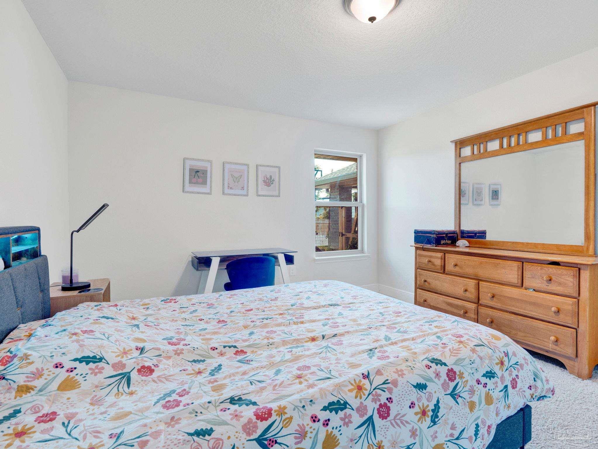 5956 Parsonage Circle Milton, FL 32570 - Photo 43 of 66 a bedroom with a bed and a dresser