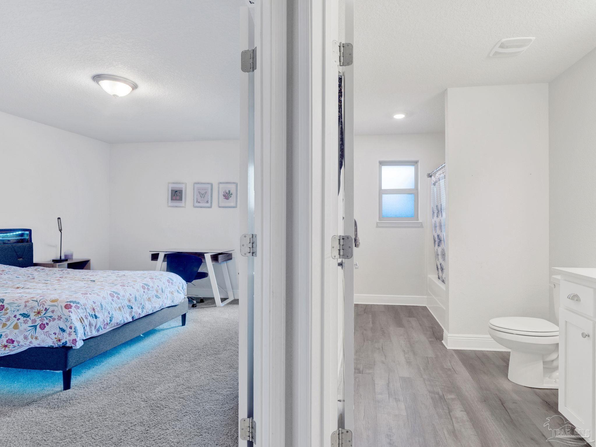 5956 Parsonage Circle Milton, FL 32570 - Photo 44 of 66 a bedroom with a bed and a view of bathroom