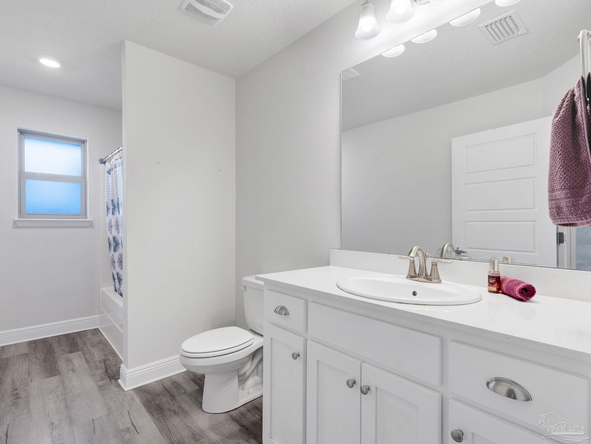 5956 Parsonage Circle Milton, FL 32570 - Photo 45 of 66 a bathroom with a sink vanity mirror and toilet