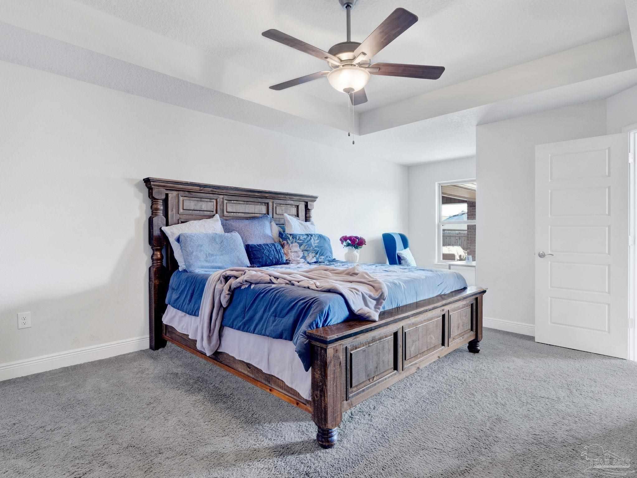 5956 Parsonage Circle Milton, FL 32570 - Photo 49 of 66 a bed sitting in a bedroom and chandelier