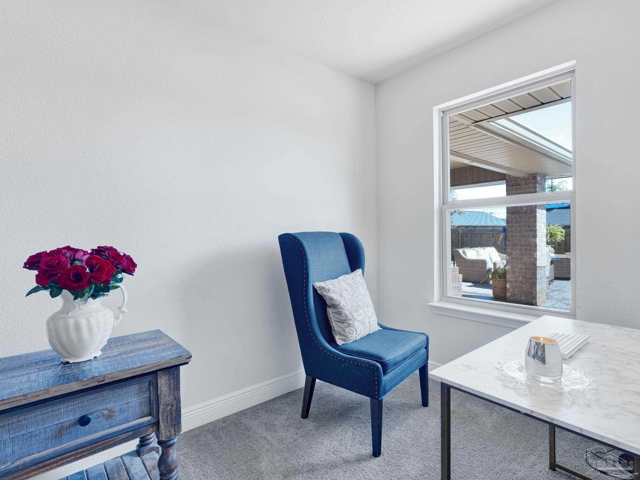 5956 Parsonage Circle Milton, FL 32570 - Photo 50 of 66 a living room with furniture and flowers