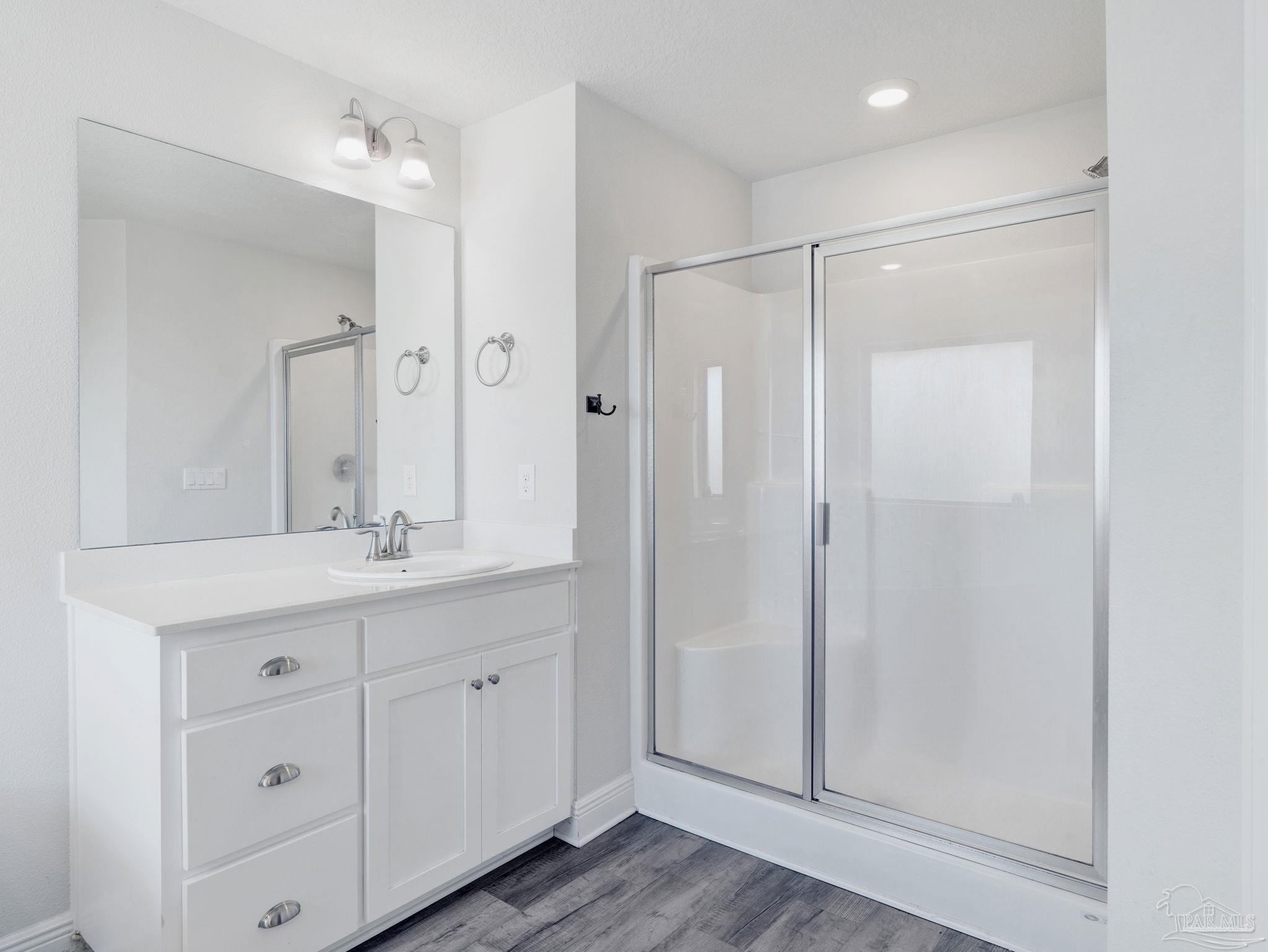 5956 Parsonage Circle Milton, FL 32570 - Photo 52 of 66 a bathroom with a double vanity sink mirror and shower