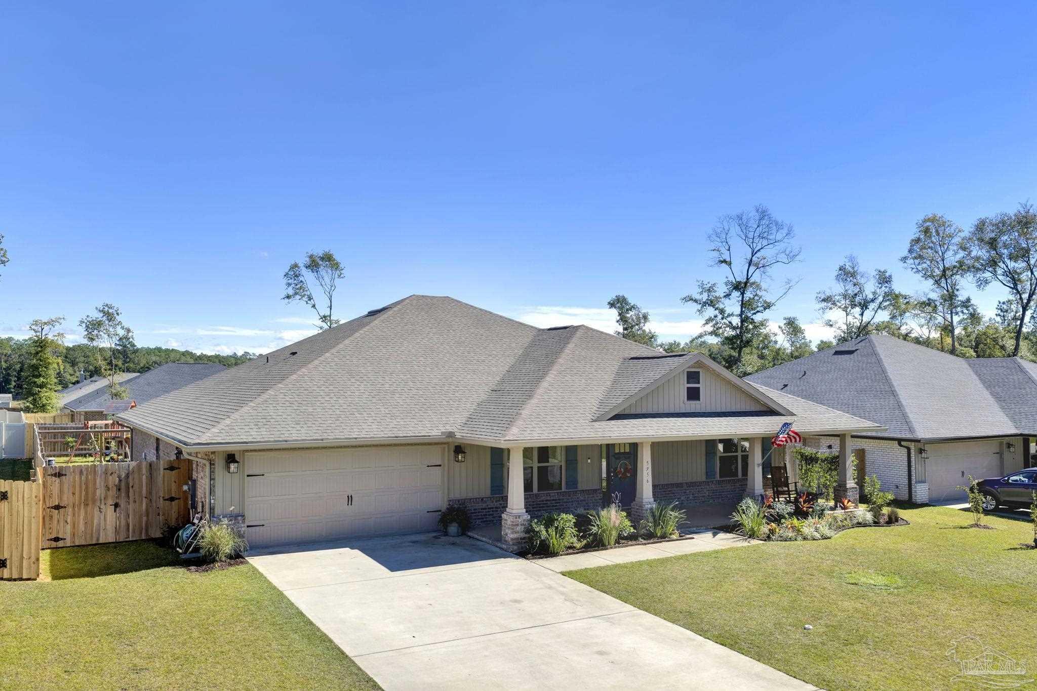 5956 Parsonage Circle Milton, FL 32570 - Photo 57 of 66 a front view of a house with a yard