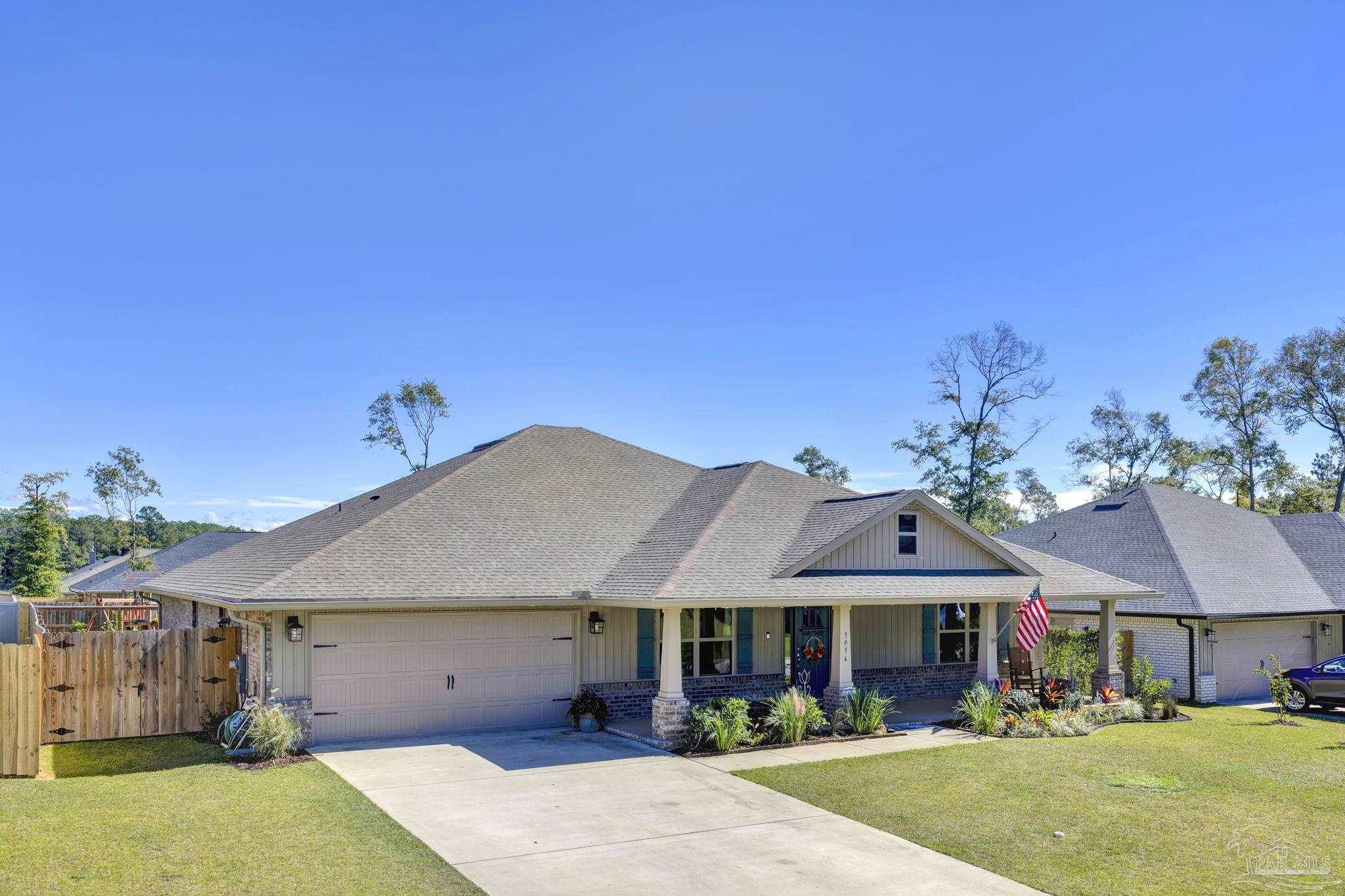 5956 Parsonage Circle Milton, FL 32570 - Photo 59 of 66 a front view of a house with a garden