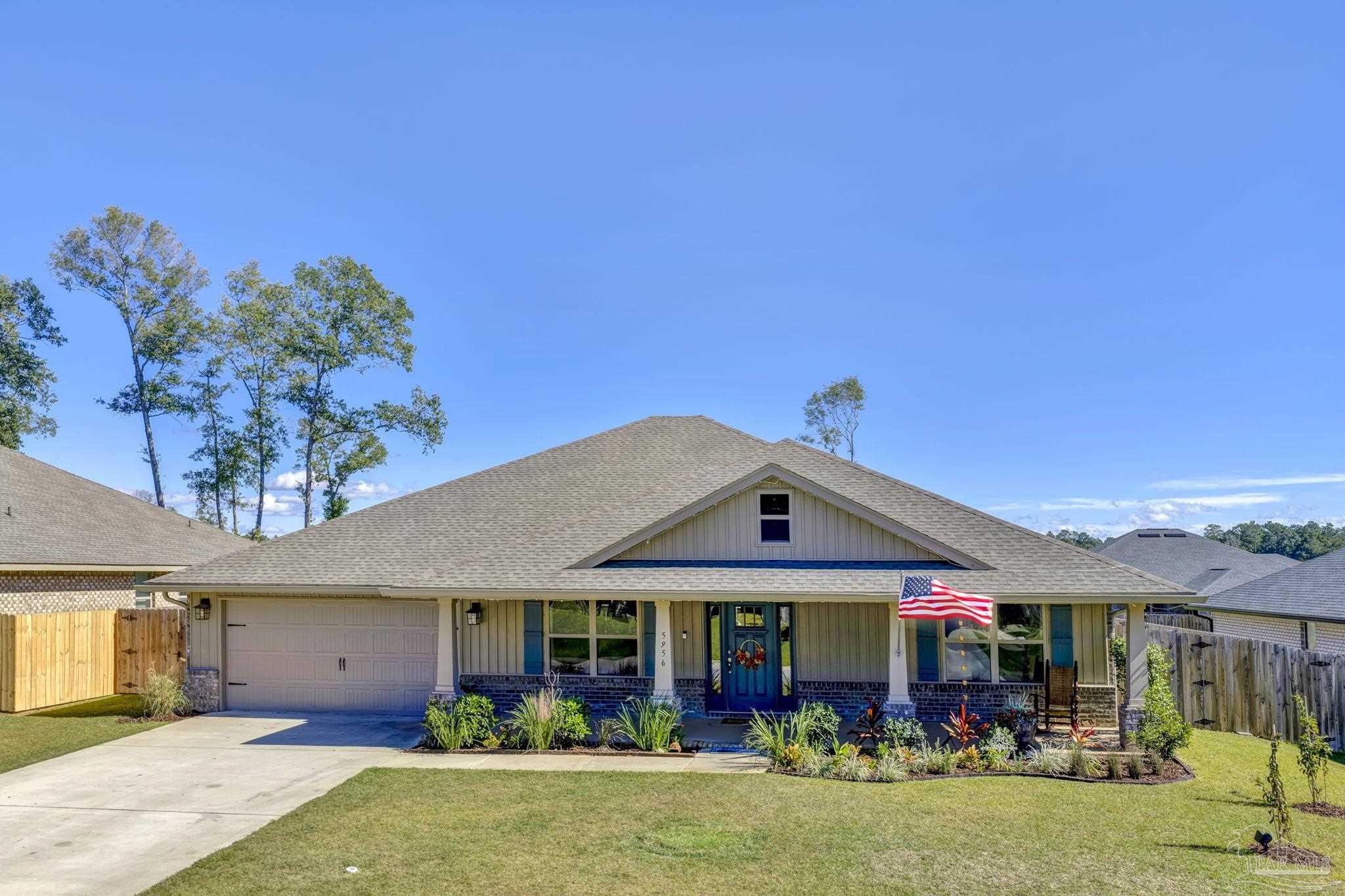 5956 Parsonage Circle Milton, FL 32570 - Photo 64 of 66 a front view of a house with garden