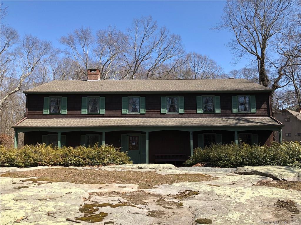 8 Money Point Road Stonington, CT 06355 - Photo 1 of 1 a front view of a building with a garden