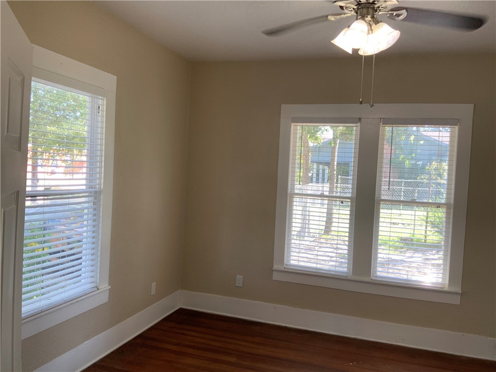 207 North Archer Street Groesbeck, TX 76642 - Photo 8 of 25 a view of an empty room with wooden floor and a window