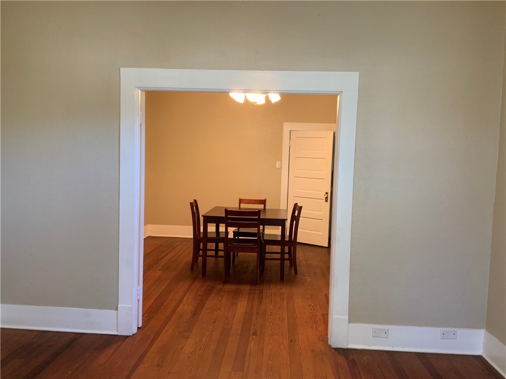 207 North Archer Street Groesbeck, TX 76642 - Photo 9 of 25 a view of a dining room with furniture and wooden floor