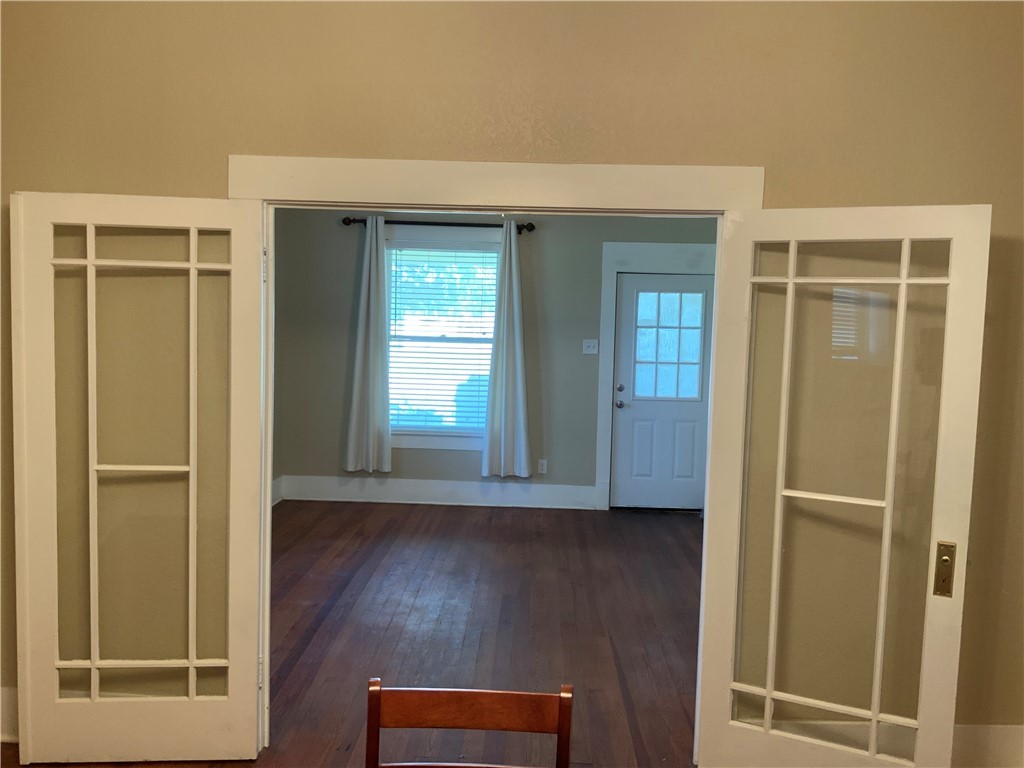 207 North Archer Street Groesbeck, TX 76642 - Photo 10 of 25 hallway with wooden floor and front door