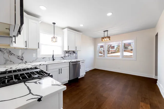a kitchen with a sink stove and cabinets