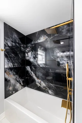 a bathroom with a shower and a sink