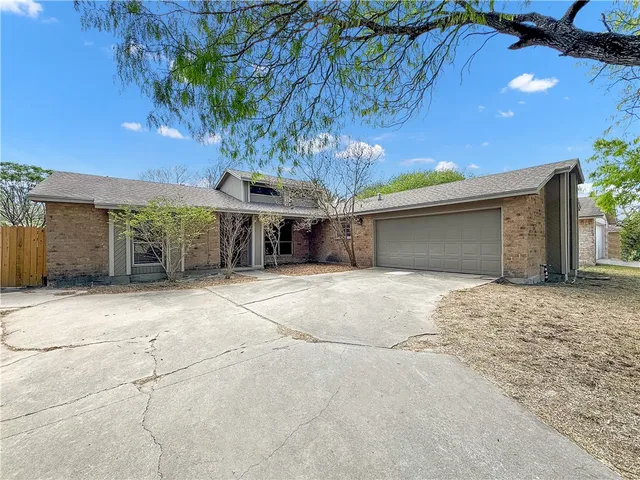 a view of a house with a yard and garage