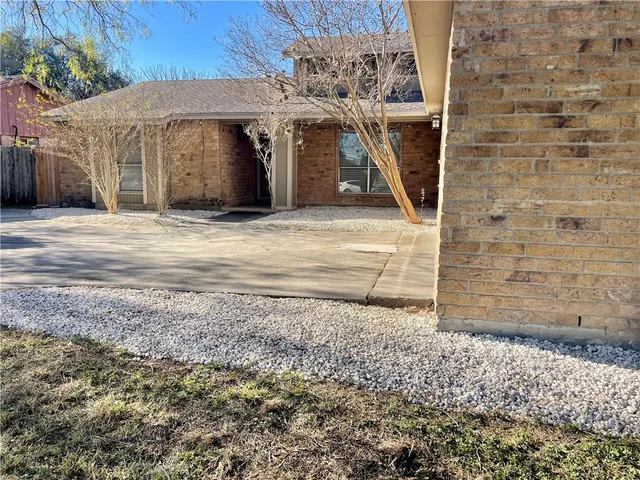 a view of a grey house with a door