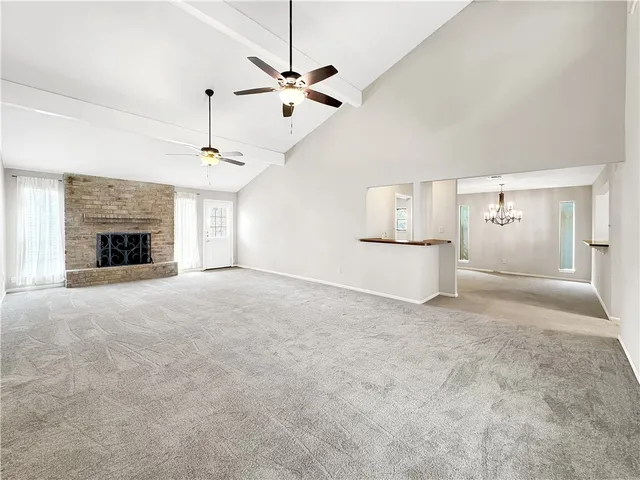 a view of empty room with a fireplace and window