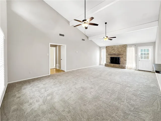 a view of empty room with a fireplace