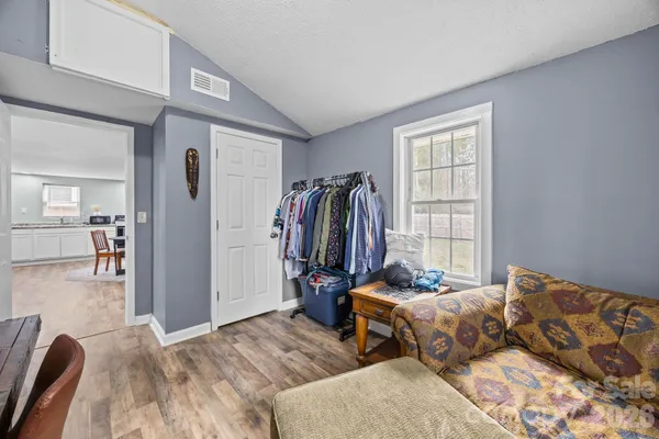a bedroom with furniture and a window