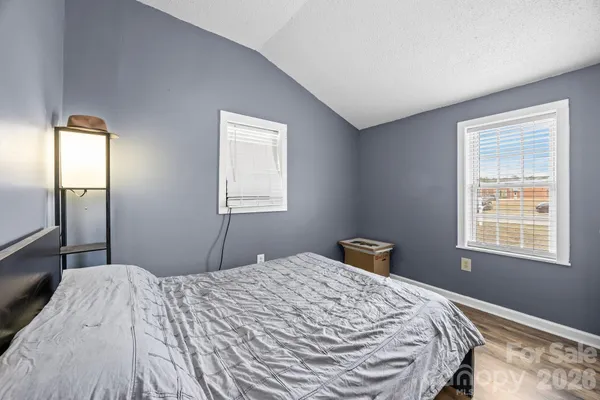 a bedroom with a bed and window