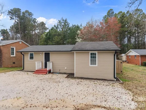 a backyard of a house with barbeque oven and backyard