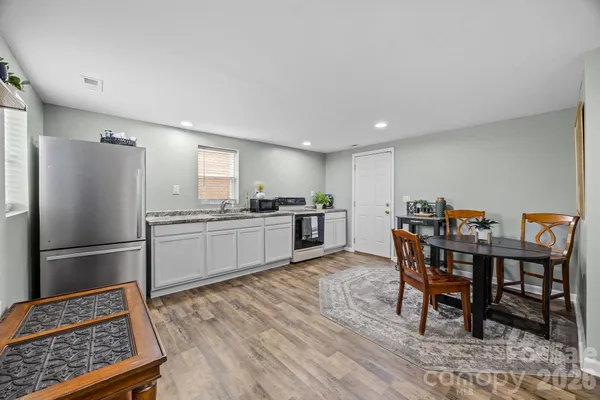 a kitchen with kitchen island a dining table and chairs