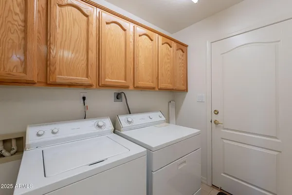 a view of storage and utility room with washer and dryer