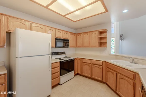 a white refrigerator freezer sitting in a kitchen