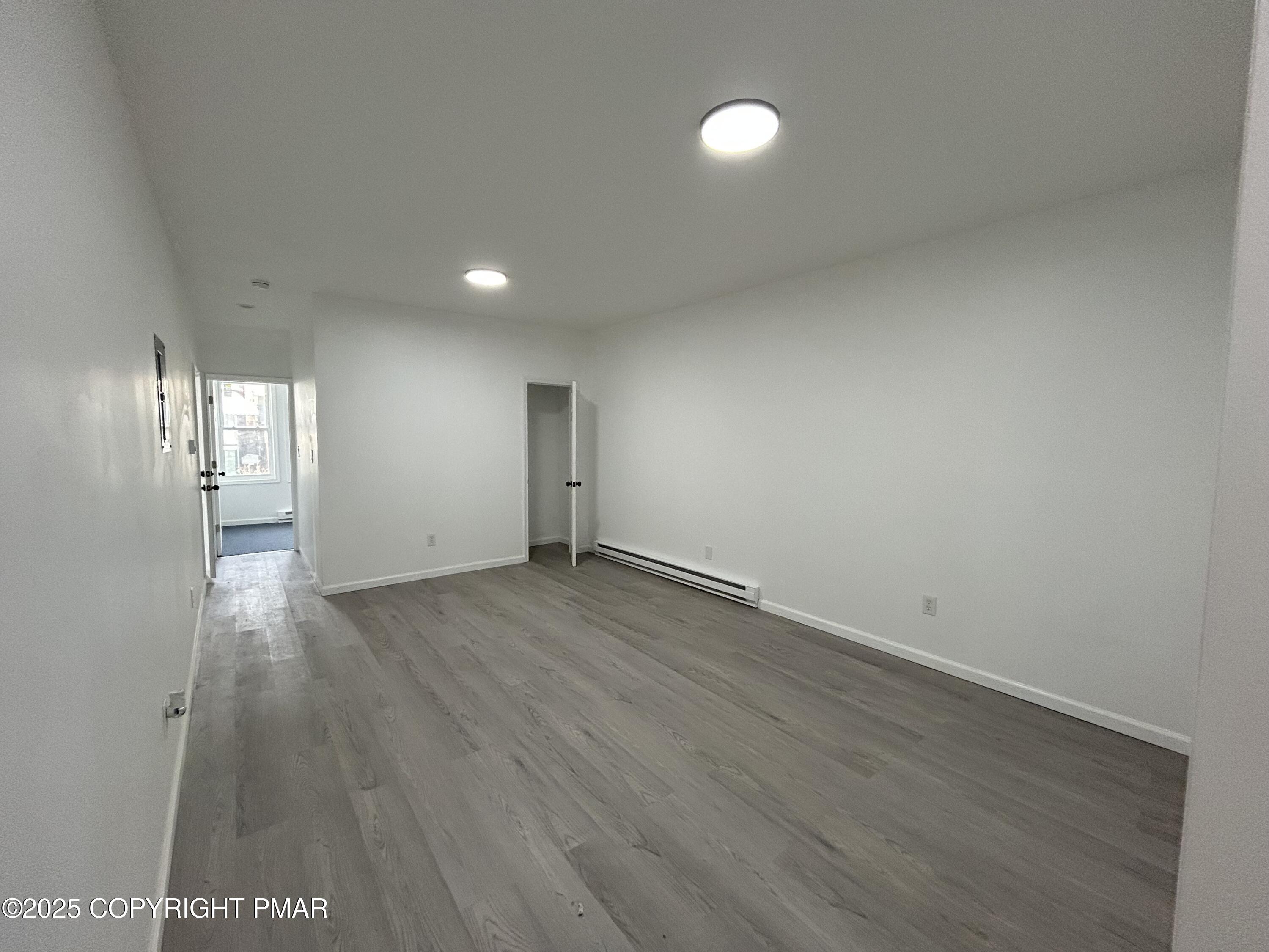 222 West Patterson Street, Unit 1 Lansford, PA 18232 - Photo 5 of 12 an empty room with wooden floor and windows