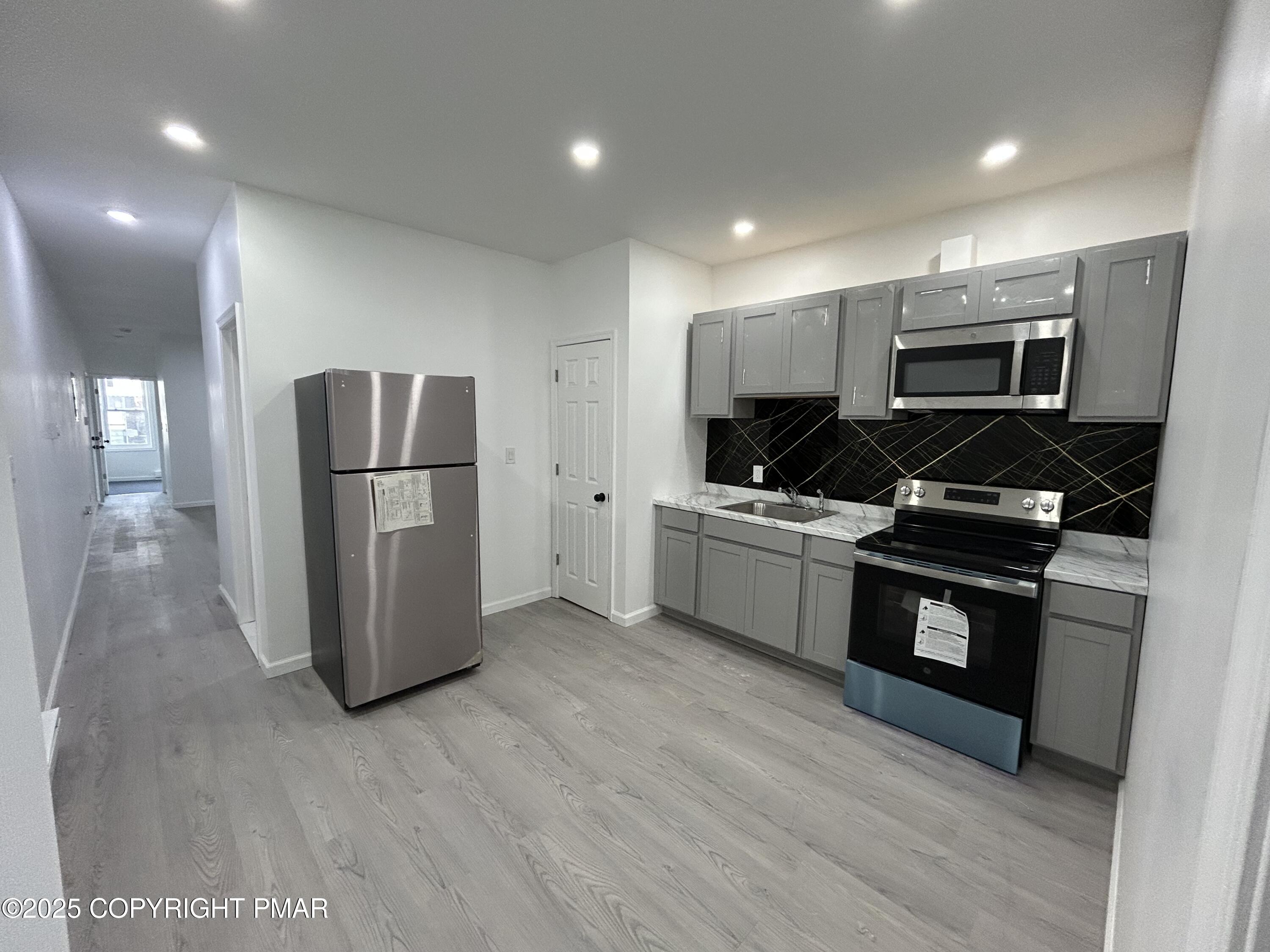 222 West Patterson Street, Unit 1 Lansford, PA 18232 - Photo 8 of 12 a kitchen with a refrigerator and a stove top oven