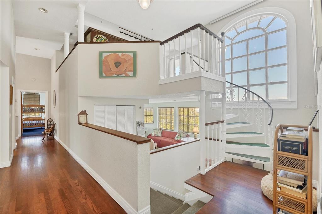 1660 16th Street East Boca Grande, FL 33921 - Photo 15 of 48 a hallway with wooden floor and stairs