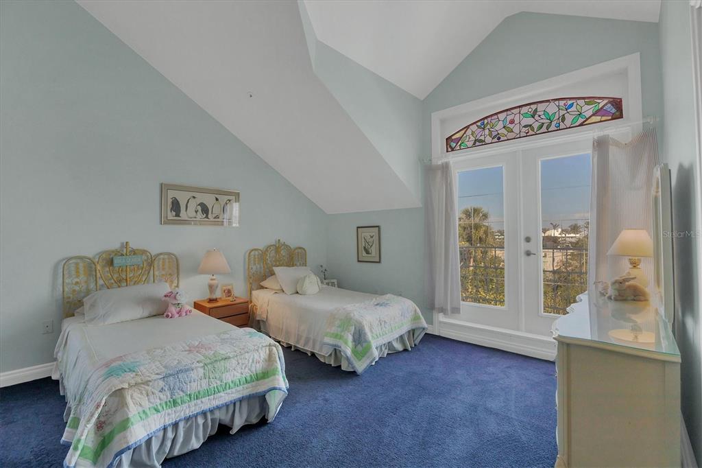 1660 16th Street East Boca Grande, FL 33921 - Photo 18 of 48 a bedroom with two beds and a window