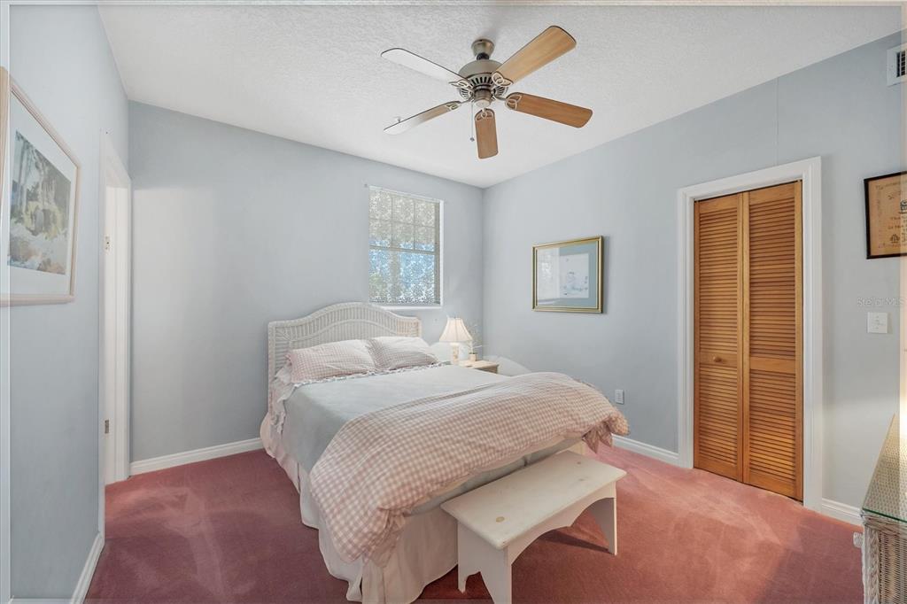 1660 16th Street East Boca Grande, FL 33921 - Photo 20 of 48 a bedroom with a bed and a chandelier