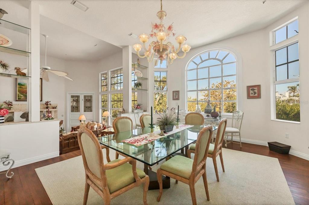 1660 16th Street East Boca Grande, FL 33921 - Photo 25 of 54 a dining room with furniture a chandelier and wooden floor