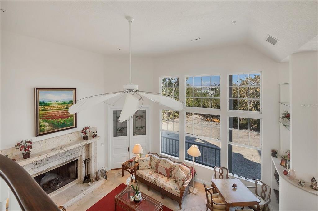 1660 16th Street East Boca Grande, FL 33921 - Photo 30 of 54 a living room with furniture a flat screen tv and a fireplace