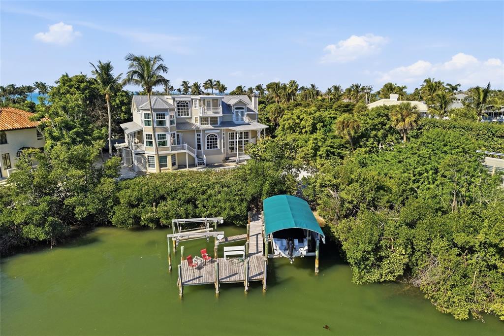 1660 16th Street East Boca Grande, FL 33921 - Photo 34 of 48 a table and chairs sitting in the middle of a lake