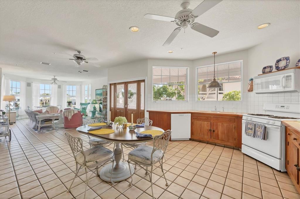 1660 16th Street East Boca Grande, FL 33921 - Photo 10 of 48 a kitchen with a sink dining table and chairs