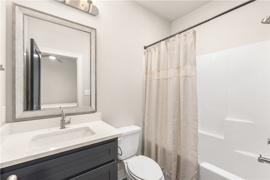 705 Turner Street College Station, TX 77840 - Photo 11 of 19 a bathroom with a sink a toilet and shower curtain