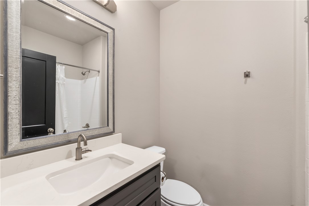 705 Turner Street College Station, TX 77840 - Photo 13 of 19 a bathroom with a sink vanity mirror and toilet