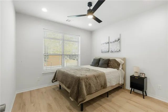 a bedroom with a bed and a window