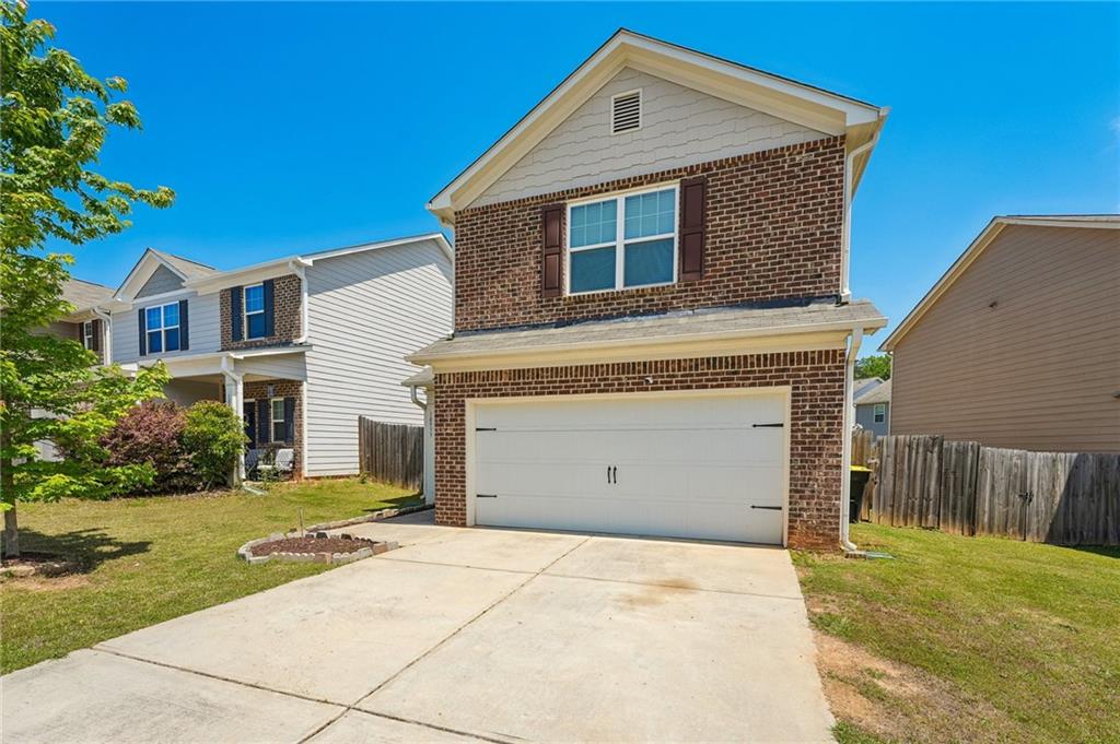 10933 Wheeler Trace Hampton, GA 30228 - Photo 2 of 22 a front view of a house with a yard