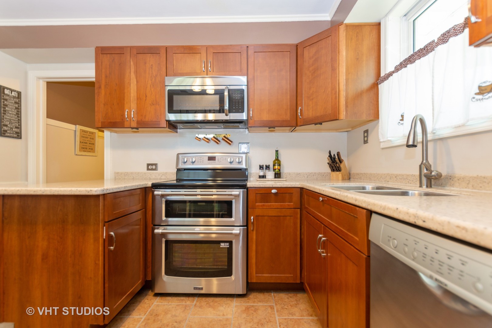 2233 Spruce Road Homewood, IL 60430 - Photo 7 of 17 a kitchen with stainless steel appliances granite countertop a sink a stove a microwave and wooden cabinets