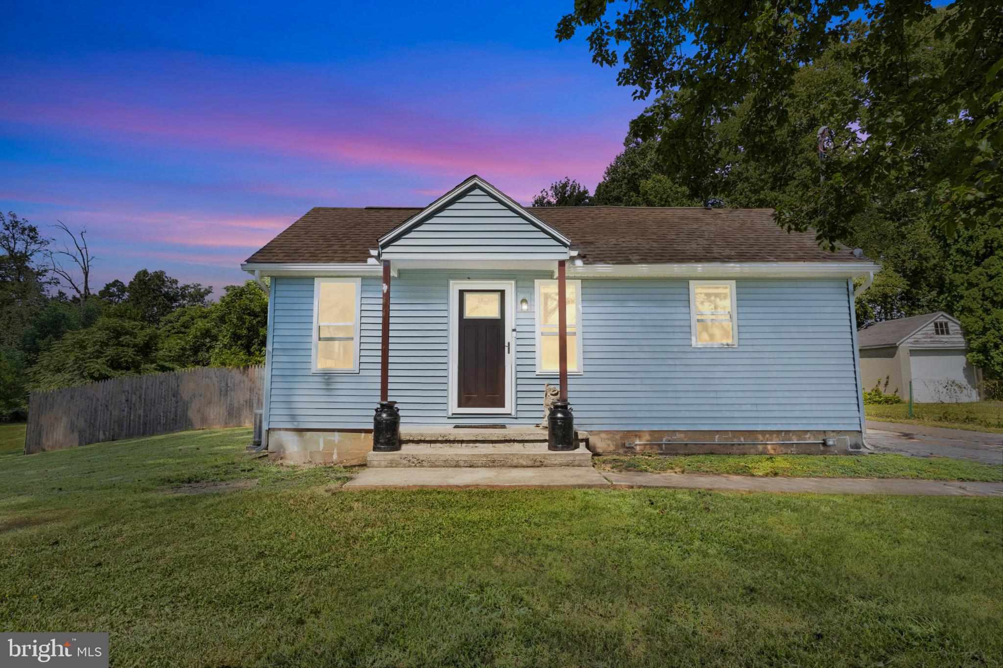 575 Cassel Road Manchester, PA 17345 - Photo 1 of 33 Charming blue home under a vibrant sunset.