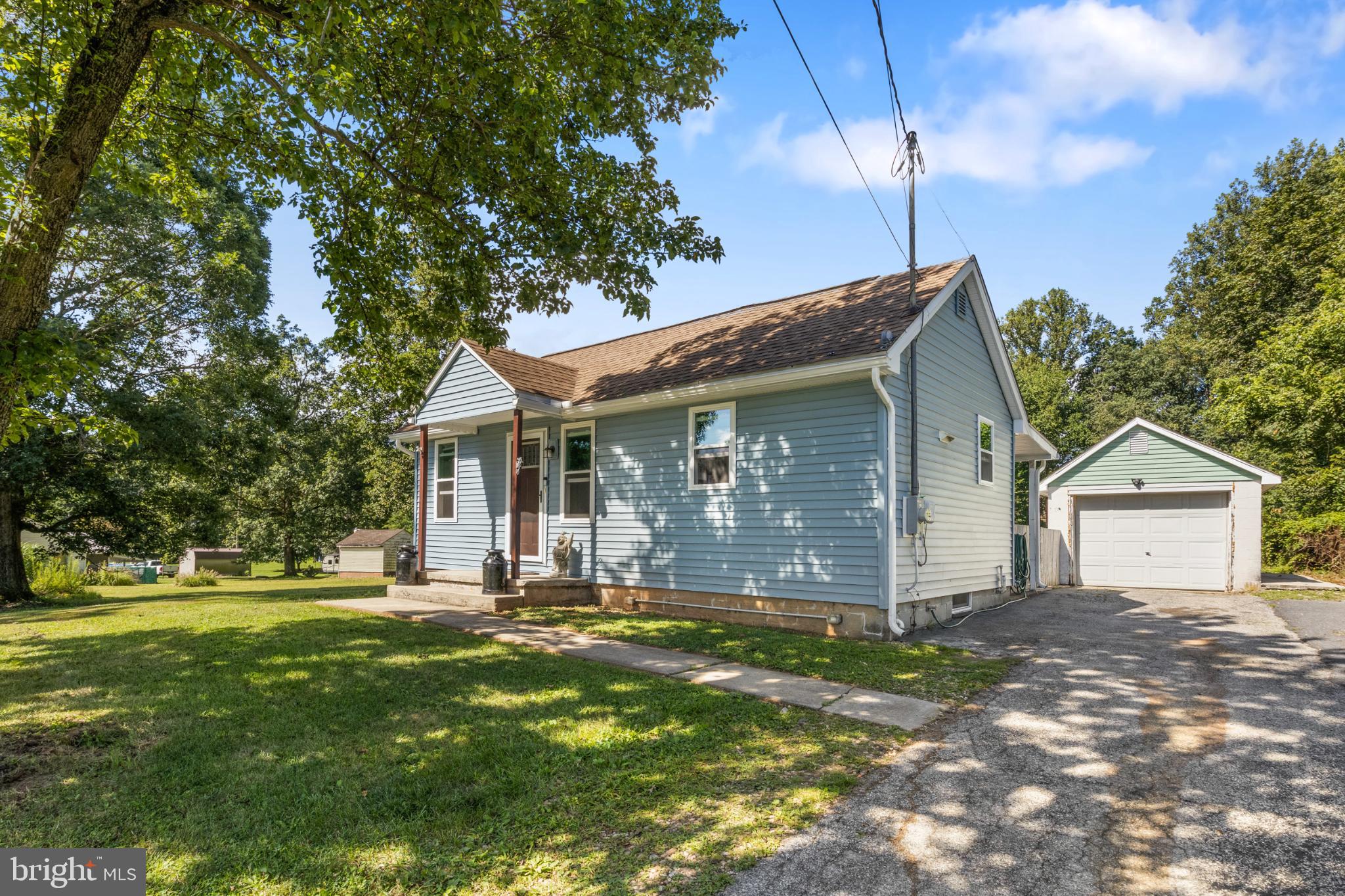 575 Cassel Road Manchester, PA 17345 - Photo 5 of 33 Charming blue home nestled in lush greenery.
